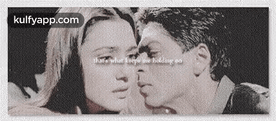 A Black And White Photo Of A Man Kissing A Woman . GIF
