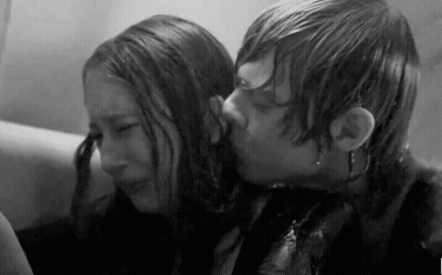 A Black And White Photo Of A Man Kissing A Woman In A Bathtub . GIF