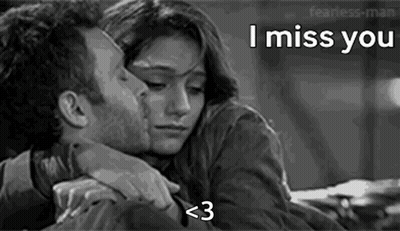 A Black And White Photo Of A Man Kissing A Woman On The Forehead . GIF