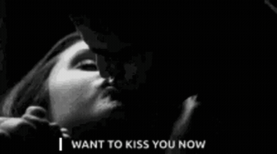 A Black And White Photo Of A Man Kissing A Woman . GIF