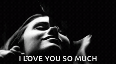 A Black And White Photo Of A Man Kissing A Woman 'S Forehead . GIF