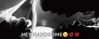 A Black And White Photo Of A Man Kissing A Woman With The Words Hey Handsome Below Them GIF