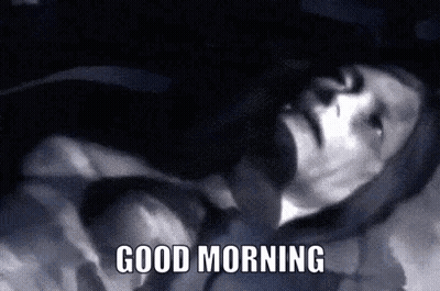 A Black And White Photo Of A Man Laying Down With The Words Good Morning Written Below Him . GIF