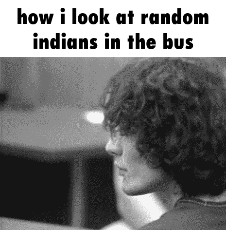 A Black And White Photo Of A Man Looking At Random Indians In The Bus . GIF