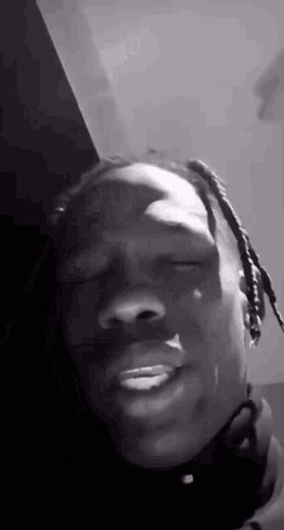 A Black And White Photo Of A Man Making A Funny Face . GIF