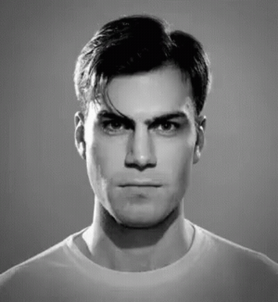 A Black And White Photo Of A Man Making A Funny Face GIF
