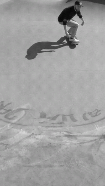 A Black And White Photo Of A Man On A Skateboard With A Drawing Of A Key And A Skateboard On The Ground GIF