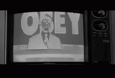 A Black And White Photo Of A Man On A Television Screen With The Word Obey On It . GIF