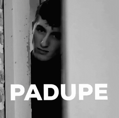 A Black And White Photo Of A Man Peeking Out From Behind A Wall With The Word Padupe In White GIF