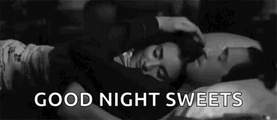 A Black And White Photo Of A Man Petting A Woman 'S Head While They Sleep . GIF