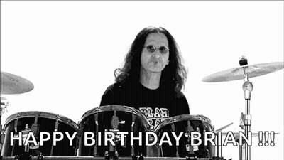 A Black And White Photo Of A Man Playing Drums With The Words `` Happy Birthday Brian '' Behind Him . GIF