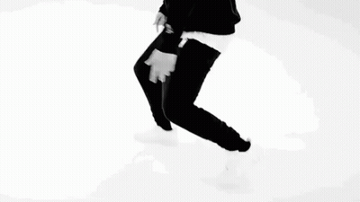 A Black And White Photo Of A Man Pointing At His Chest . GIF
