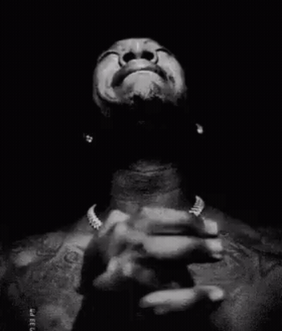 A Black And White Photo Of A Man Praying With His Hands Folded In Prayer . GIF