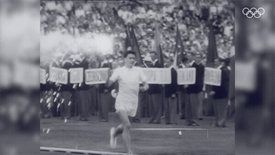 A Black And White Photo Of A Man Running With A Sign That Says ' Freedom ' On It GIF