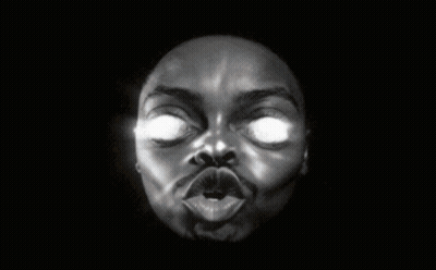 A Black And White Photo Of A Man 'S Face With Glowing Eyes GIF