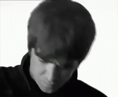 A Black And White Photo Of A Man 'S Face With His Eyes Closed . GIF