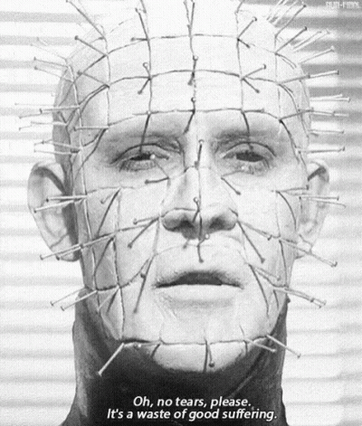 A Black And White Photo Of A Man 'S Face With Nails On It . GIF