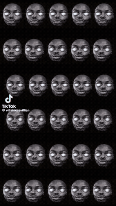 A Black And White Photo Of A Man 'S Face With White Eyes And Teeth . GIF