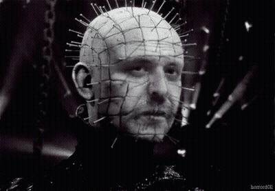 A Black And White Photo Of A Man 'S Head With Pins In It . GIF