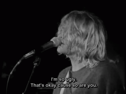 A Black And White Photo Of A Man Singing Into A Microphone GIF