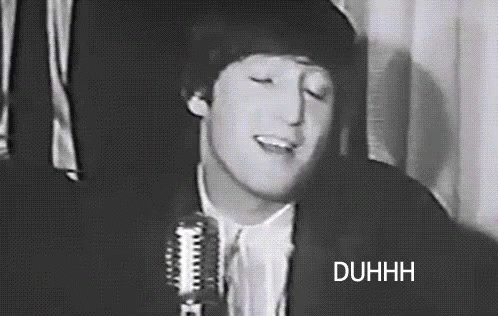 A Black And White Photo Of A Man Singing Into A Microphone With His Eyes Closed . GIF