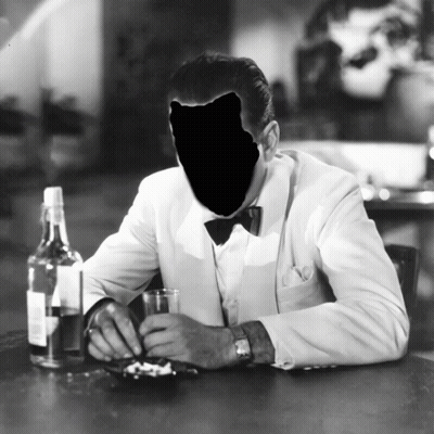 A Black And White Photo Of A Man Sitting At A Table GIF