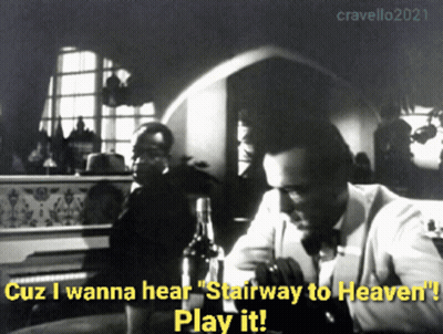 A Black And White Photo Of A Man Sitting At A Table With Stairway To Heaven Written On It GIF