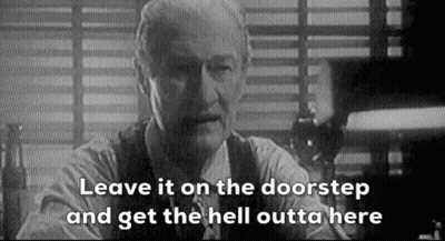 A Black And White Photo Of A Man Sitting At A Table With The Words `` Leave It On The Doorstep '' . GIF