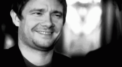 A Black And White Photo Of A Man Smiling And Making A Face . GIF