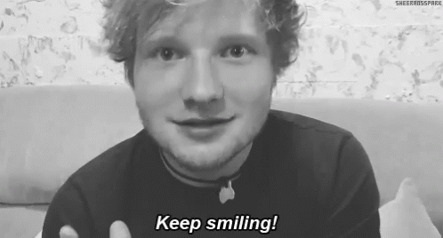A Black And White Photo Of A Man Smiling With The Words Keep Smiling Written Below Him . GIF
