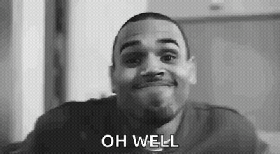 A Black And White Photo Of A Man Smiling With The Words `` Oh Well '' Written On His Face . GIF