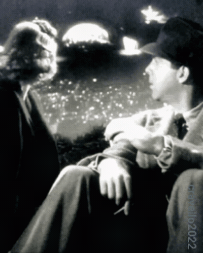 A Black And White Photo Of A Man Smoking A Cigarette With The Date 10 2022 GIF