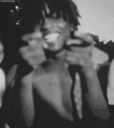 A Black And White Photo Of A Man Smoking A Cigarette With The Name Chiefkeef At The Bottom GIF