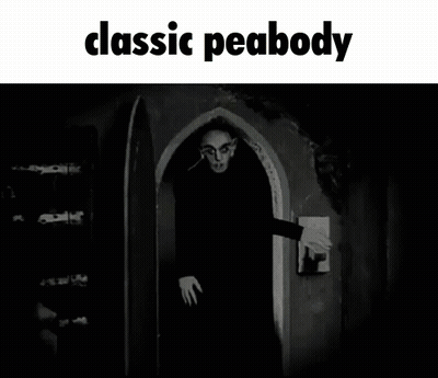 A Black And White Photo Of A Man Standing In A Doorway With The Caption Classic Peabody GIF