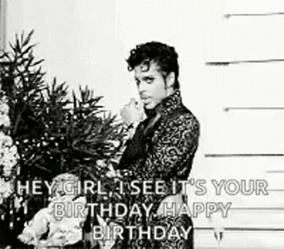 A Black And White Photo Of A Man Standing In Front Of A Christmas Tree With A Birthday Message . GIF