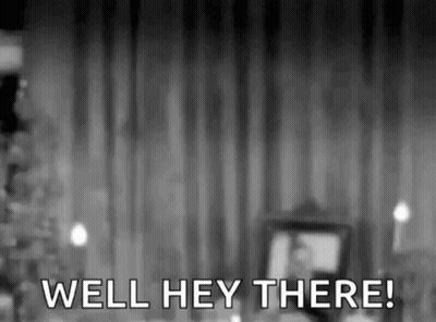 A Black And White Photo Of A Man Standing In Front Of A Curtain With The Words `` Well Hey There '' . GIF