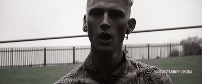 A Black And White Photo Of A Man Standing In Front Of A Fence With Worldstarhiphop.com Written On The Bottom . GIF