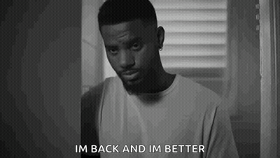 A Black And White Photo Of A Man Standing In Front Of A Window And Saying `` Im Back And Im Better '' . GIF