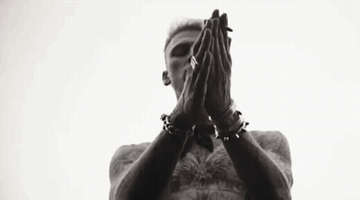 A Black And White Photo Of A Man Standing In Front Of A Window With His Hands In The Air . GIF
