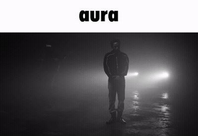 A Black And White Photo Of A Man Standing In The Fog With The Word Aura Above Him GIF