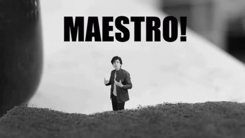 A Black And White Photo Of A Man Standing On A Hill With The Words Maestro Behind Him GIF
