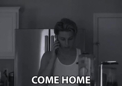A Black And White Photo Of A Man Talking On A Cell Phone With The Words Come Home Written Below Him GIF