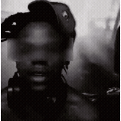 A Black And White Photo Of A Man Wearing A Baseball Cap And Headphones . GIF