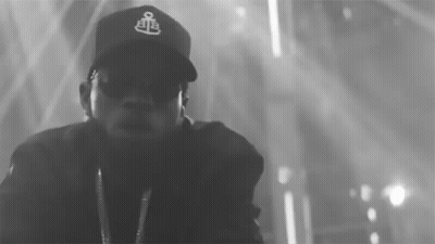 A Black And White Photo Of A Man Wearing A Baseball Cap GIF