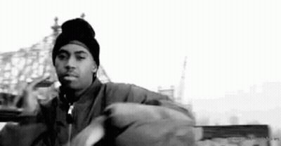 A Black And White Photo Of A Man Wearing A Beanie And Jacket . GIF