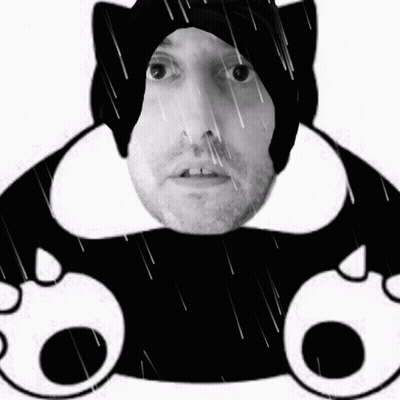 A Black And White Photo Of A Man Wearing A Black Cat Hat GIF