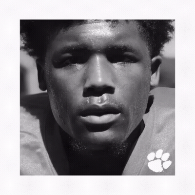 A Black And White Photo Of A Man Wearing A Clemson Football Uniform GIF
