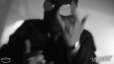 A Black And White Photo Of A Man Wearing A Gas Mask And Goggles . GIF
