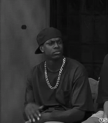 A Black And White Photo Of A Man Wearing A Hat And A Chain . GIF