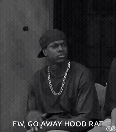A Black And White Photo Of A Man Wearing A Hat And A Necklace . GIF